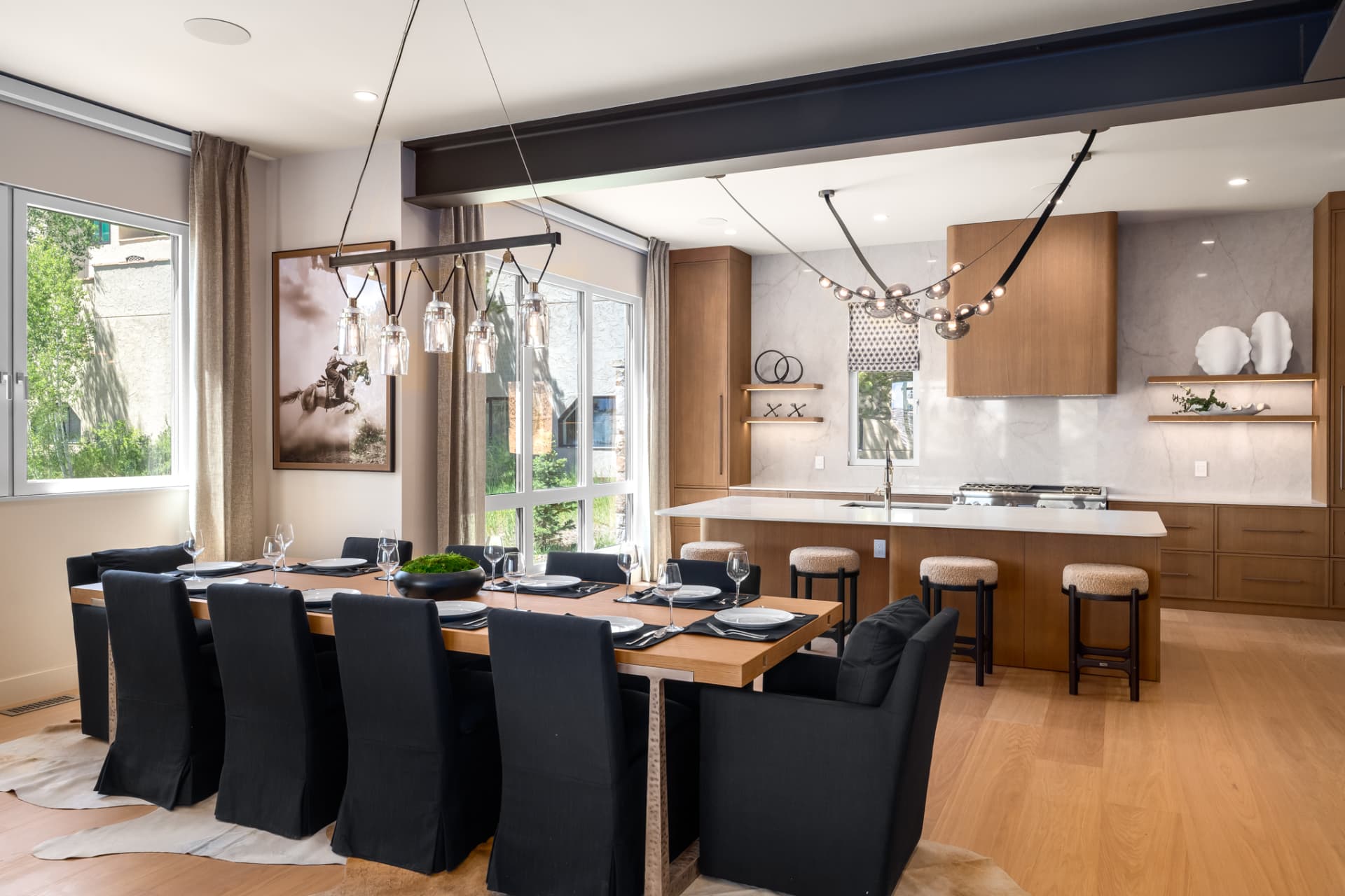 Dining table for ten with kitchen beyond and steel beam ceiling detail