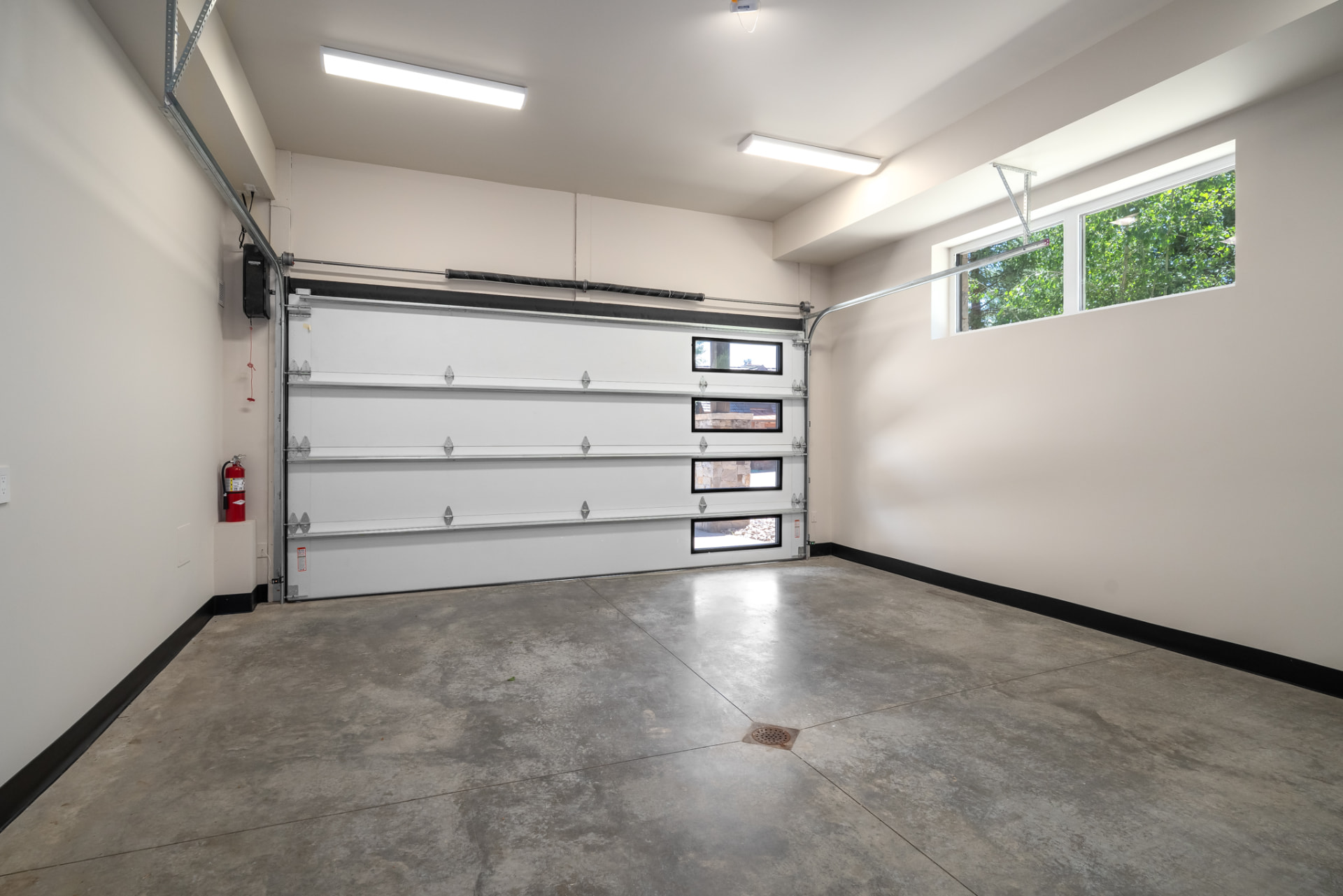 Oversized two-car garage with polished concrete floor and abundant natural light