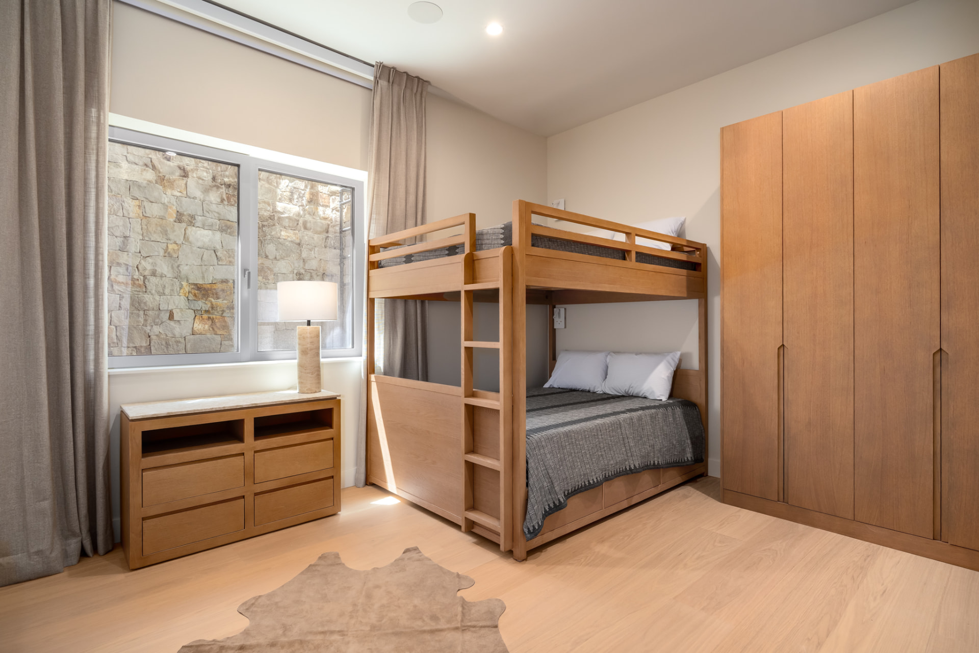 Guest bedroom with custom queen-over-queen white oak bunk beds