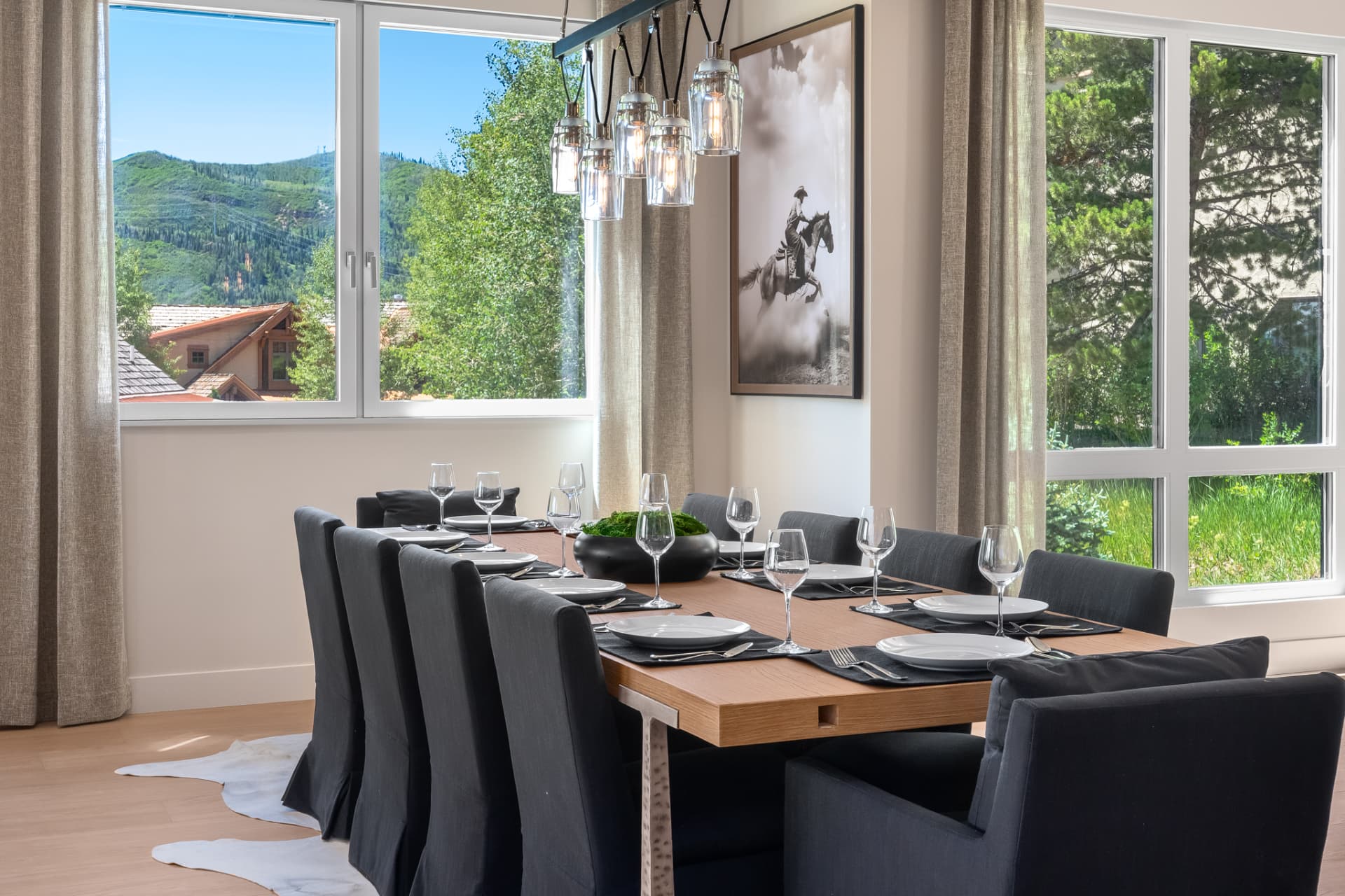 Dining room set for ten with pendant lighting and ski mountain views